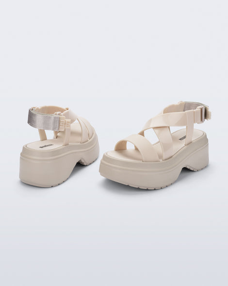 back and angled view of a pair of beige Stand platform sandals
