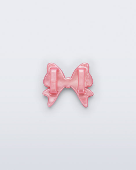 Back view of a pearly pink bow shoe charm