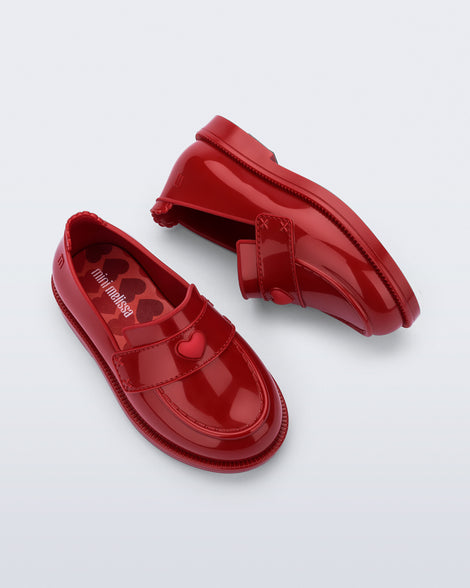 Back and top view of a pair of red Royal Love baby loafers