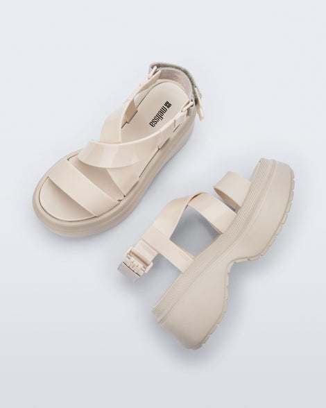 Side and top view of a pair of beige Stand platform sandals
