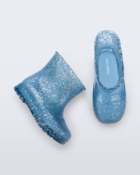 Top and side view of a pair of blue glitter Welly baby rain boots