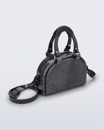 Angled view of a grey Bowling bag with black handle strap and cross body strap