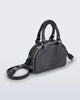 Angled view of a grey Bowling bag with black handle strap and cross body strap