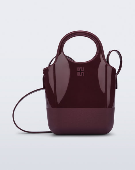 Front view of a burgundy Ultra Bag with handle and strap