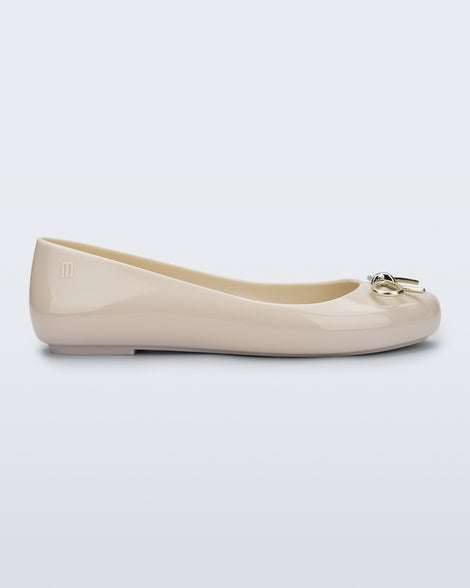 Side view of a beige Sweet Love Chrome flat with gold bow