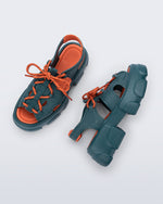 Top and side view of a pair of blue Camp platform sandals with orange laces and accents