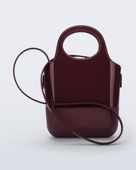 Back view of a burgundy Ultra Bag with handle and strap