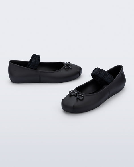 Side and angled view of a pair of black Sophie Scrunch flats