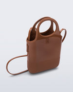 Angled view of a light brown Ultra Bag with handle and strap