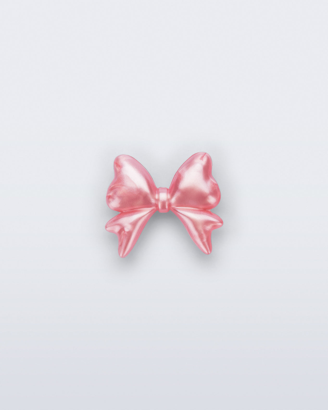 Front view of a pearly pink bow shoe charm
