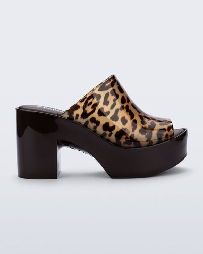 Side view of a black Mule Hype platform with clear cheetah upper