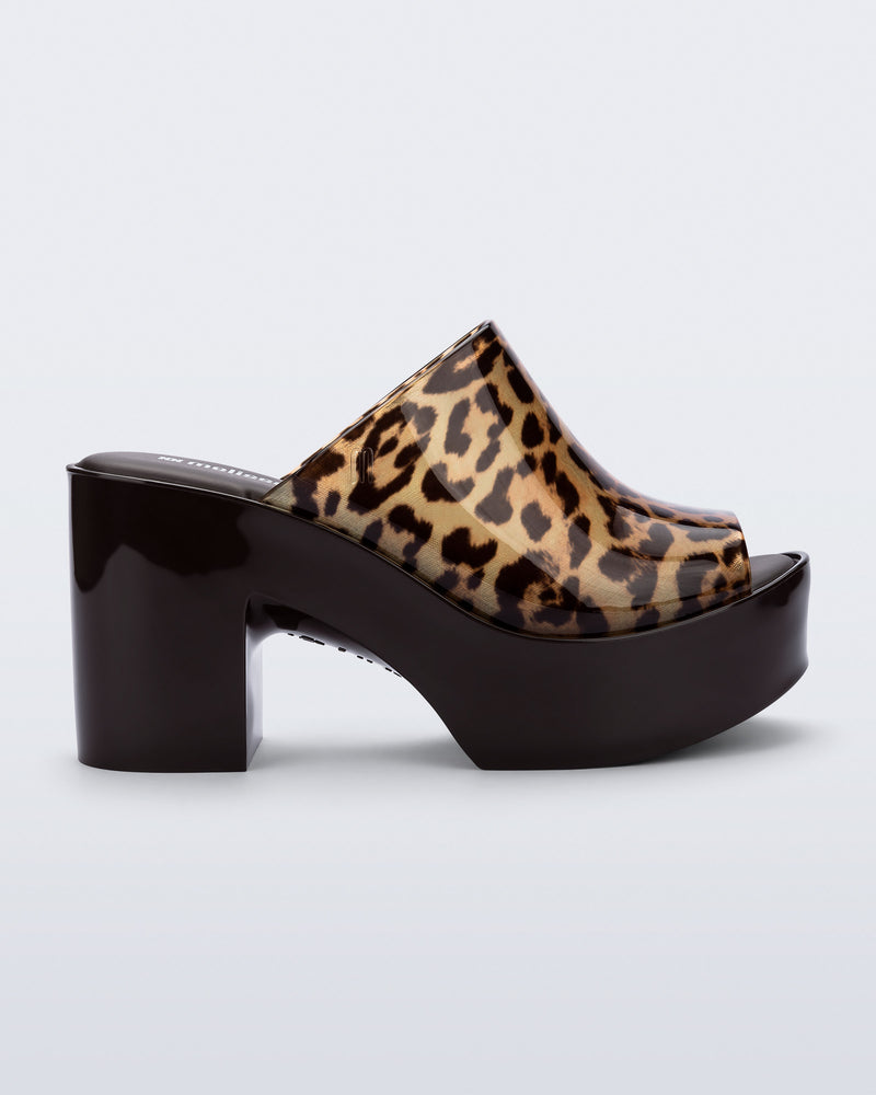 Side view of a black Mule Hype platform with clear cheetah upper