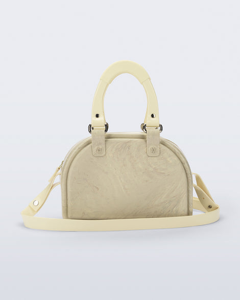 Back view of a beige Bowling bag with handle strap and cross body strap