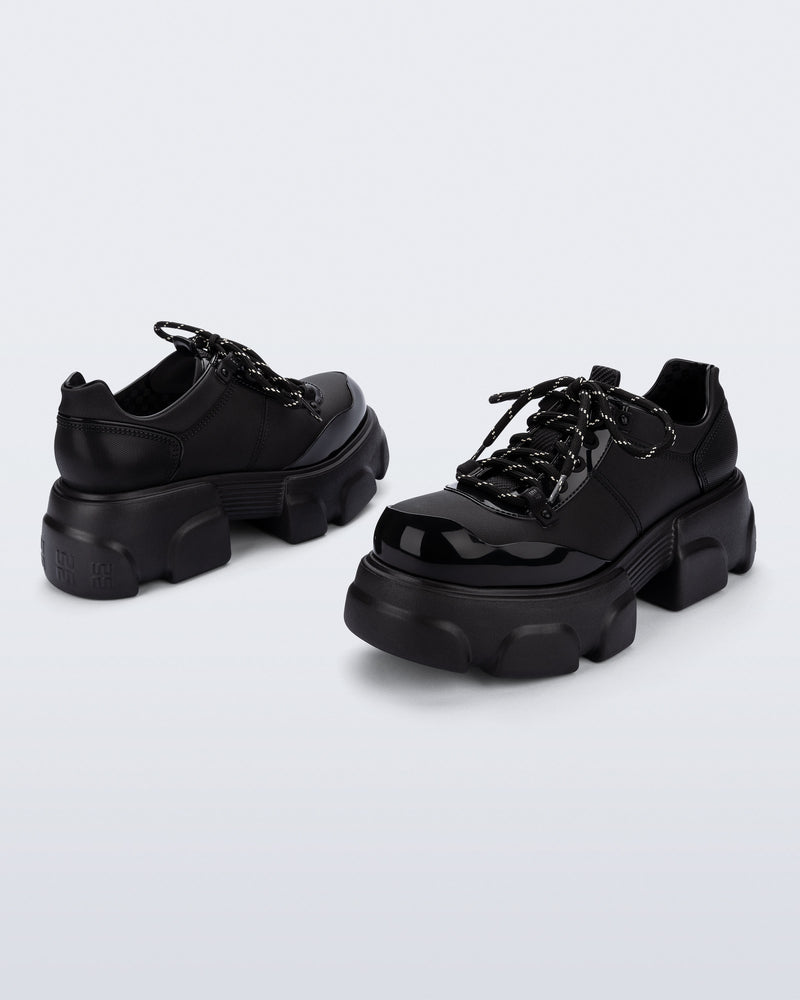 Back and angled view of a pair of black Camp platform Sneakers with black laces