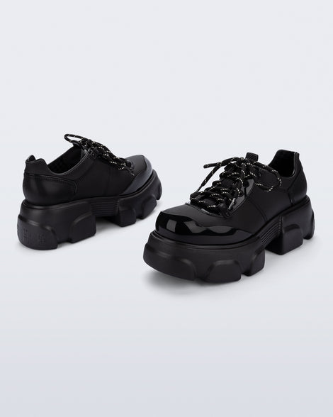 Back and angled view of a pair of black Camp platform Sneakers with black laces
