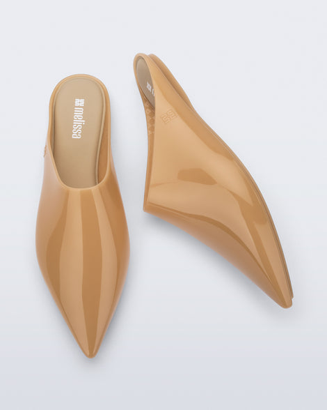 Top and side view of a pair of milky beige She slip ons with pointed toe