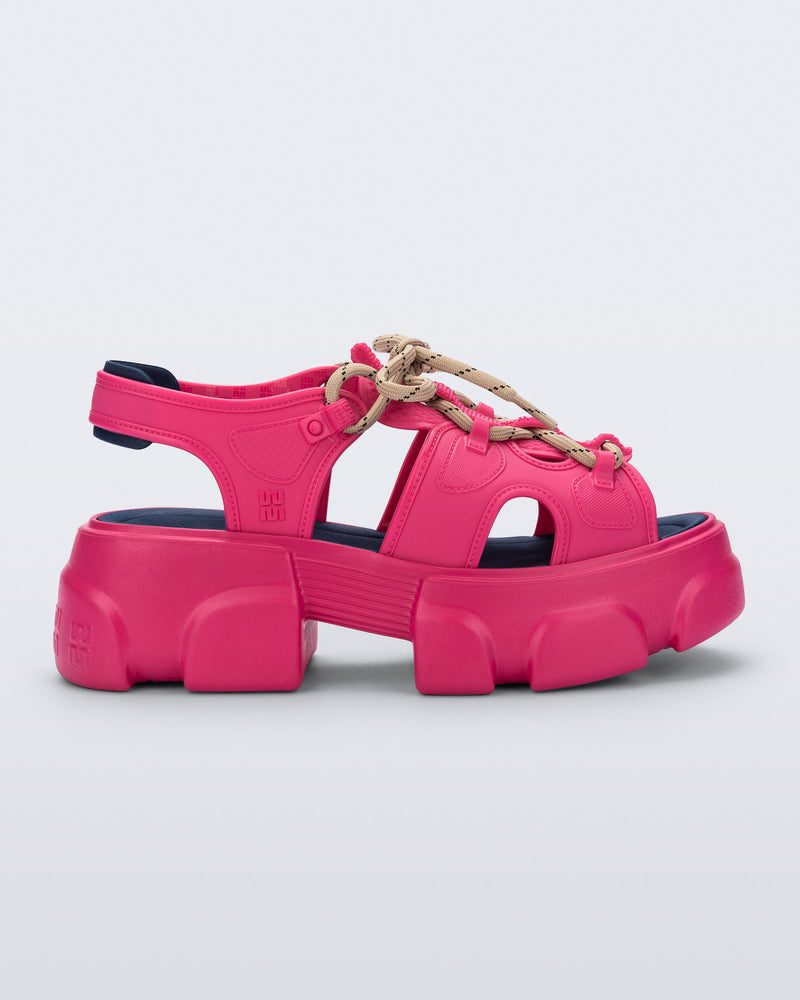 side view of a pink Camp platform sandal with beige laces and accents