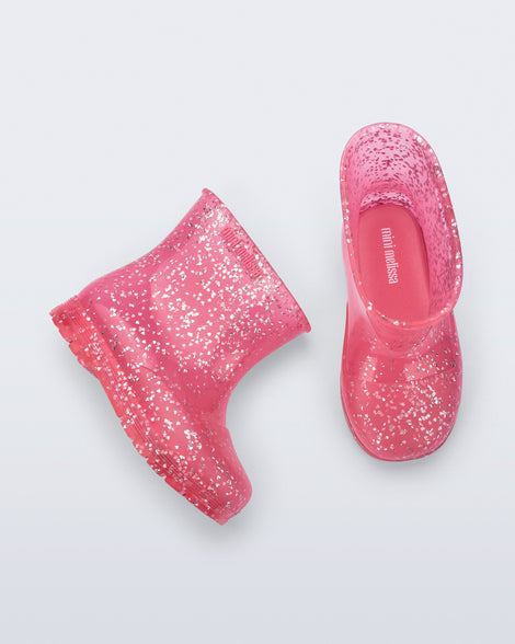 Top and side view of a pair of pink glitter Welly baby rain boots