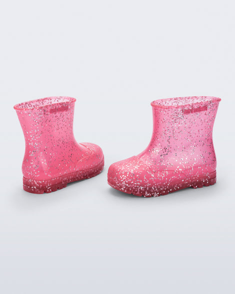 Back and side view of a pair of pink glitter Welly baby rain boots