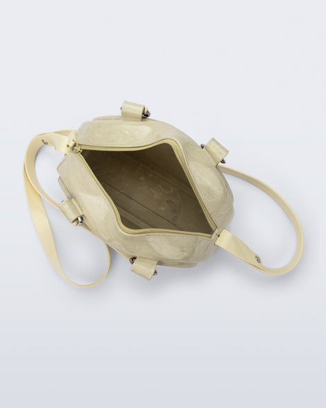 Top view of a beige Bowling bag with handle strap and cross body strap