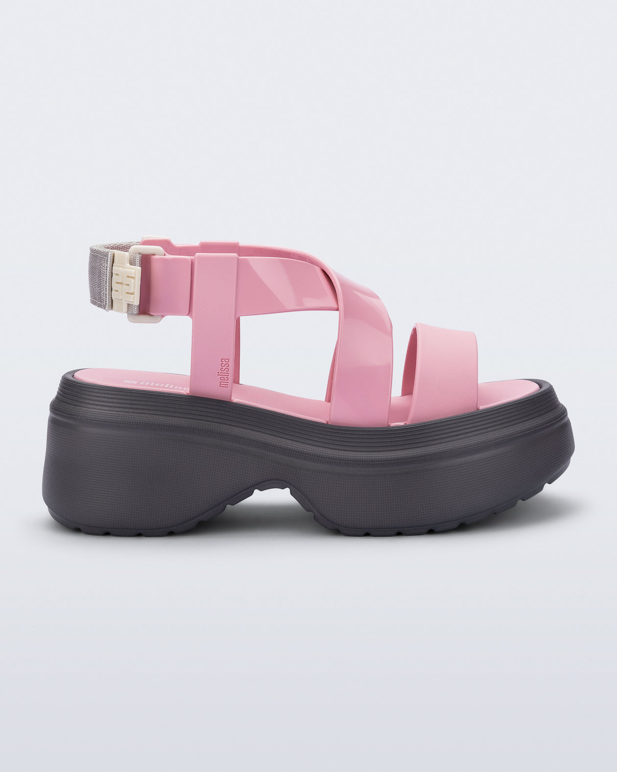 Side view of a pink Stand platform sandal with dark grey sole