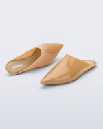 Top and angled view of a pair of milky beige She slip ons with pointed toe