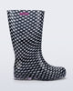 Side view of a black with white polka dots Welly rain boot