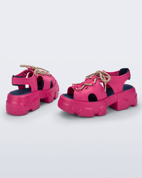 Back and angled view of a pair of pink Camp platform sandals with beige laces and accents