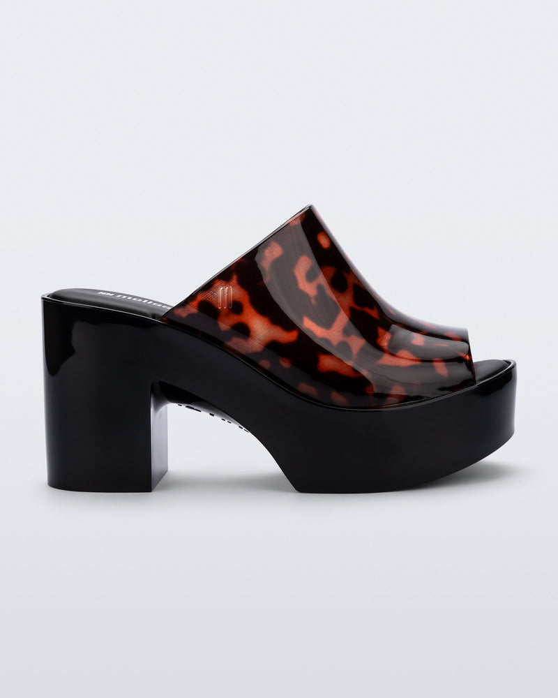 Side view of a black Mule Hype platform with tortoise upper