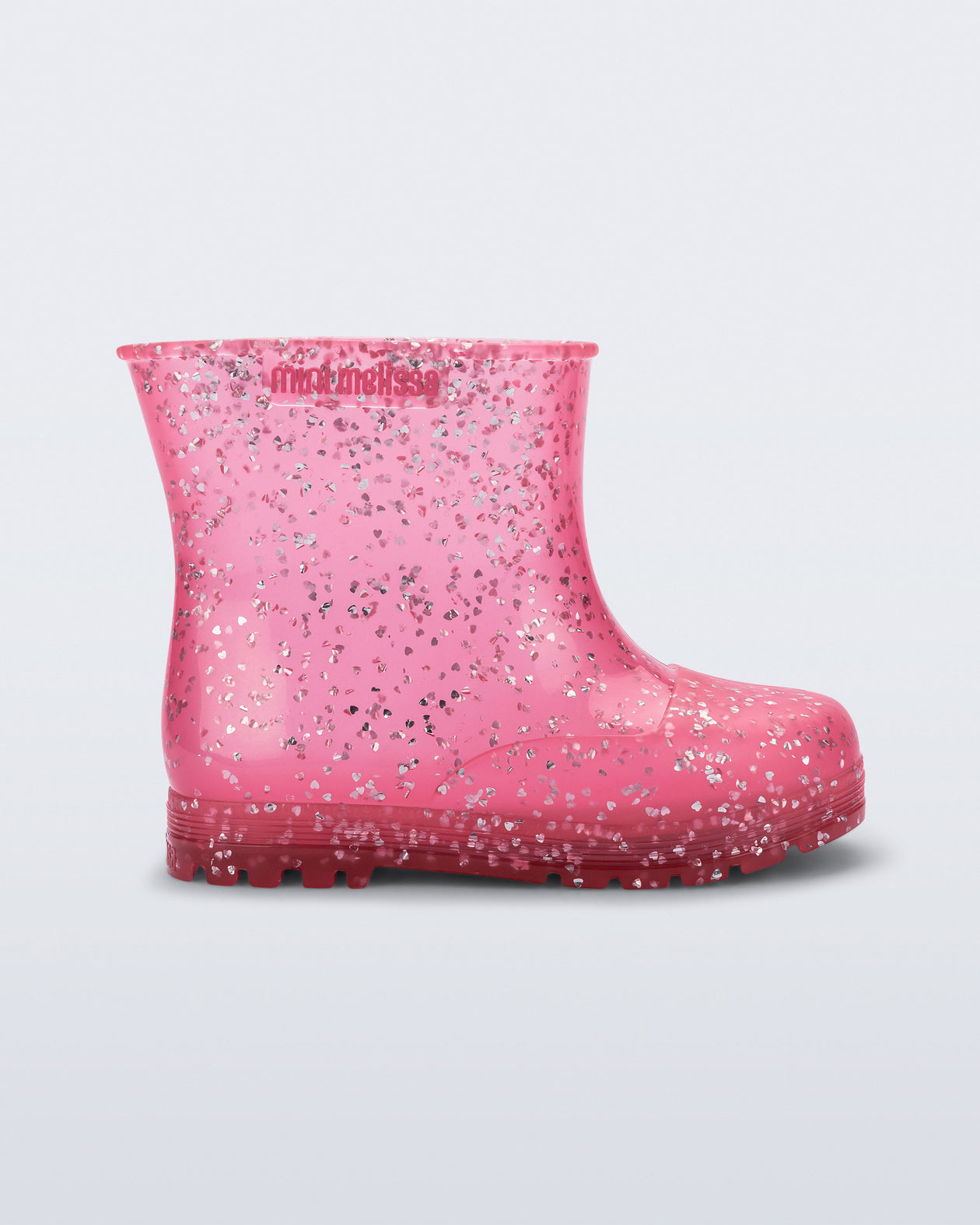 Side view of a pink glitter Welly baby rain boot
