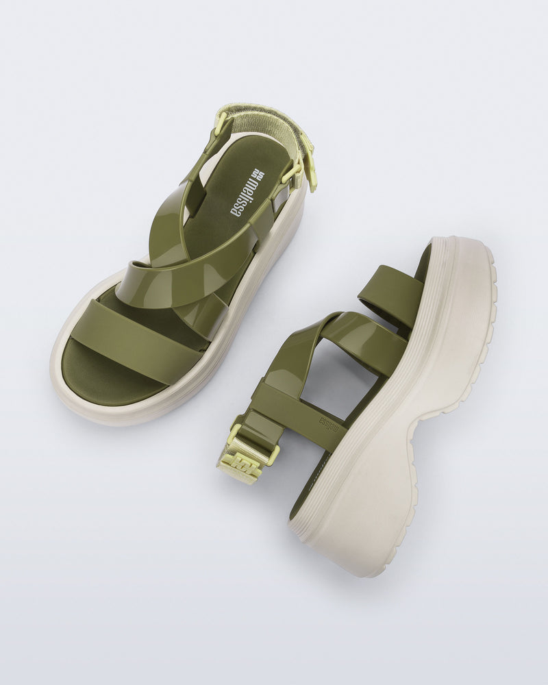 Side and top view of a pair of beige Stand platform sandals with army green straps
