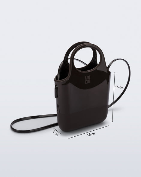 Angled view of a brown Ultra Bag with handle and strap with bag dimensions of 15cm x 5cm x 15cm