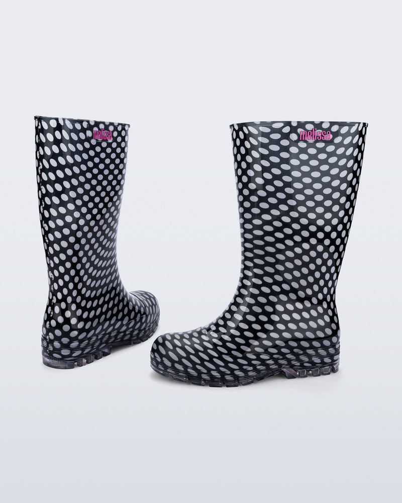 Back and angled view of a pair of black with white polka dots Welly rain boots