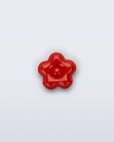 Front view of a red flower shoe charm