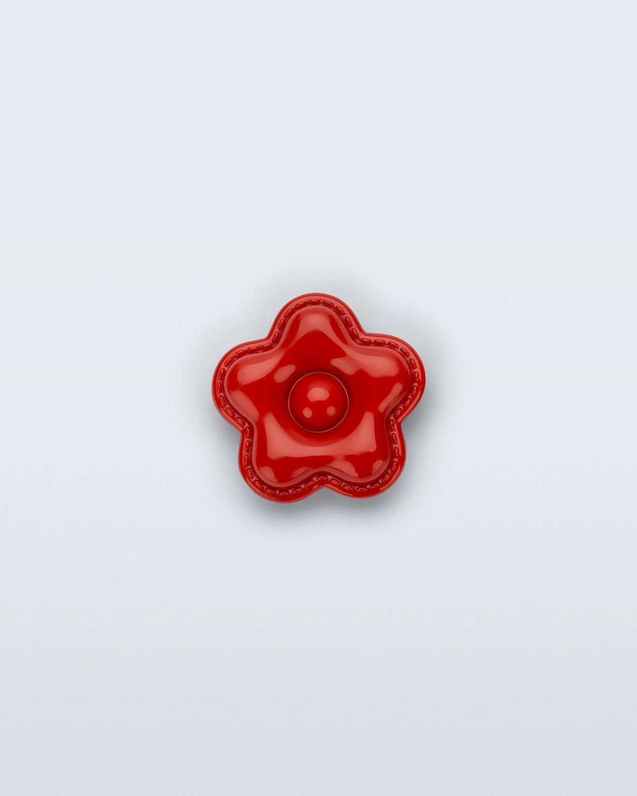 Front view of a red flower shoe charm