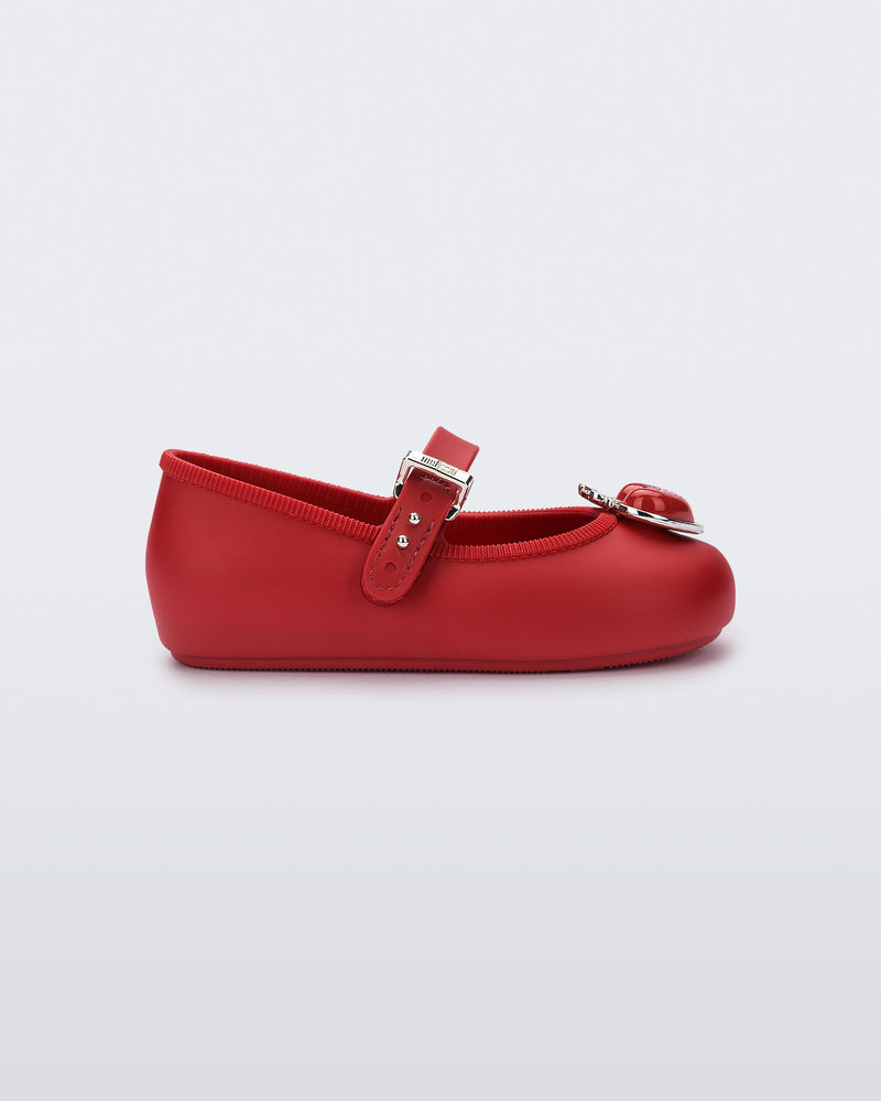 Side view of a red Soft Ballerina Princess baby flat with a red heart on top