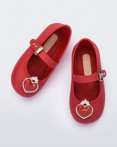 Top view of a pair of red Soft Ballerina Princess baby flats with a red heart on top