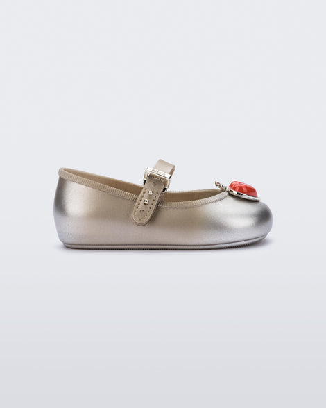 Side view of a gold/silver Soft Ballerina Princess baby flat with a red heart on top