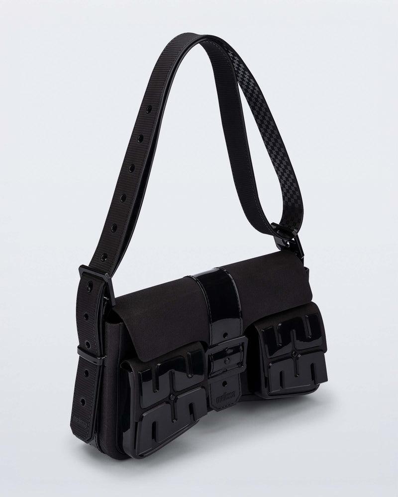 Angled view of a black Cargo bag with two small pockets on the front and an adjustable strap