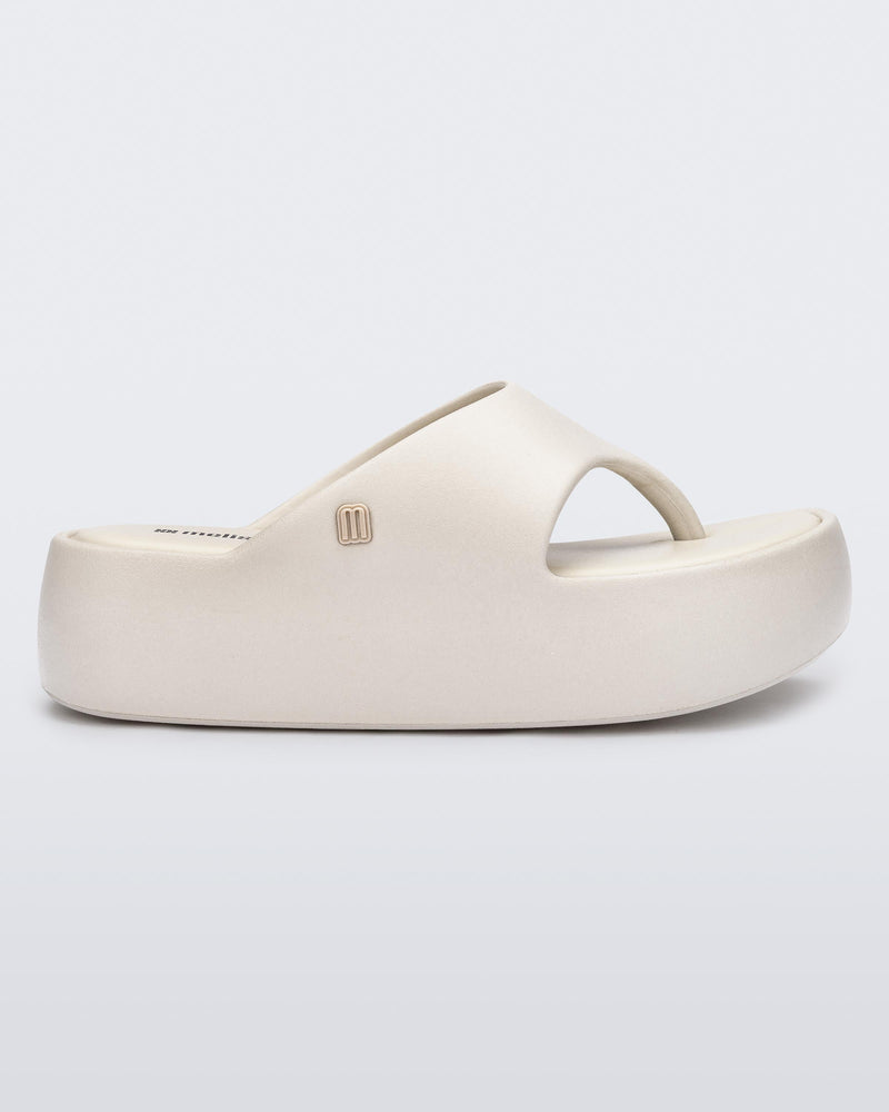 Side view of a beige Free Platform Thong sandal