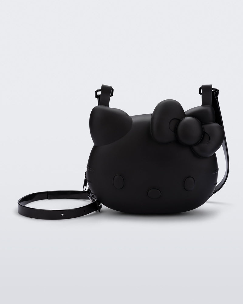 Front view of a black Hello Kitty + Friends Cute Bag with the face of Hello Kitty