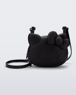 Front view of a black Hello Kitty + Friends Cute Bag with the face of Hello Kitty