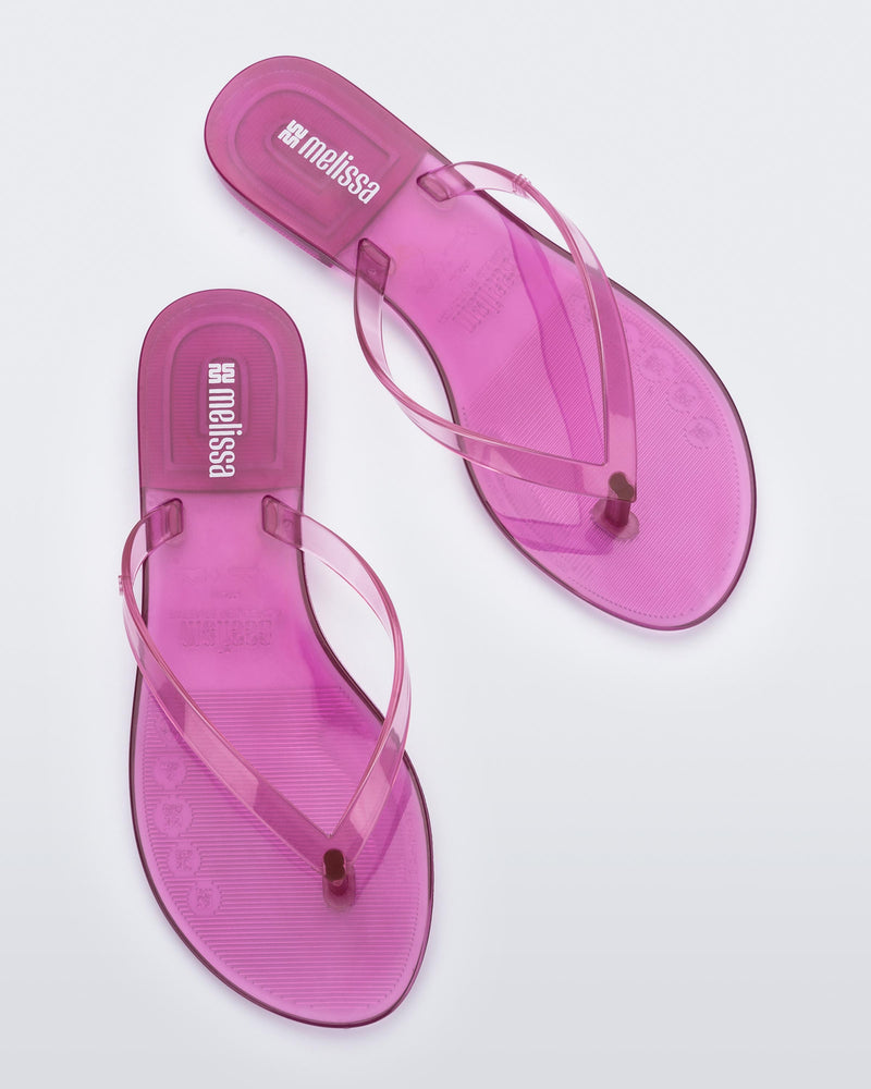 Top view of a pair of clear lilac Harmonic Jelly flip flops