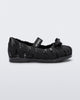 Side view of a glitter black M Lover Ballerina baby flat with bow and strap