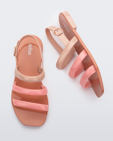 Side and top view of a pair of a beige and pink Essential Wave women's sandal with adjustable buckle.