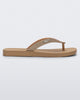 Side view of a beige with brown glitter strap Sun Long Beach flip flop