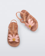 Angled and top view of a pair of pearly brown baby Hip Bloomy sandal with pink flower