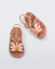 Angled and top view of a pair of pearly brown baby Hip Bloomy sandal with pink flower