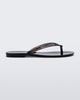 Side view of a clear black Harmonic Jelly flip flop