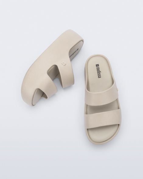 Top and side view of a pair of beige Free Line Platform slides